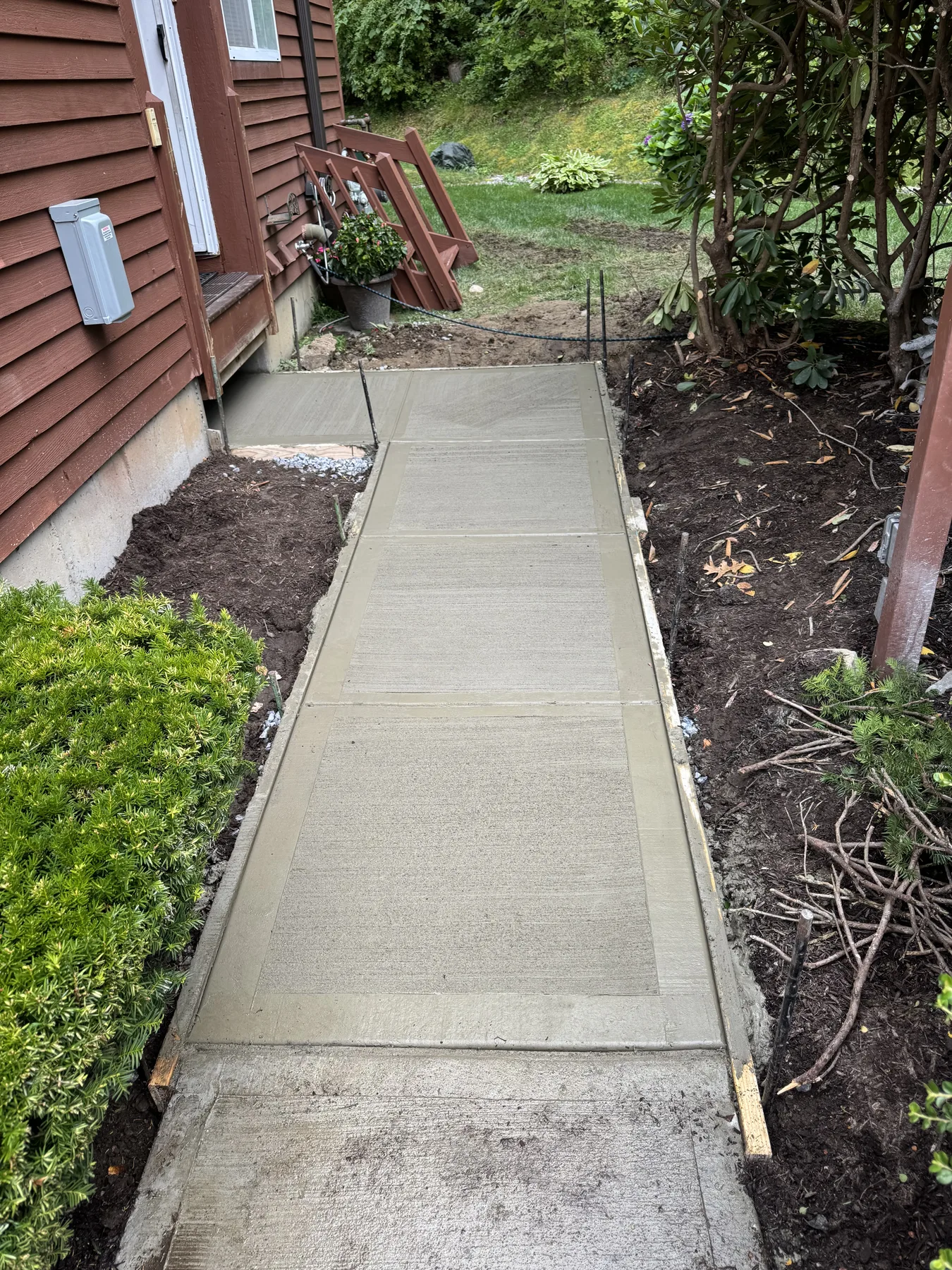 Completed concrete walkway with a clean broom finish