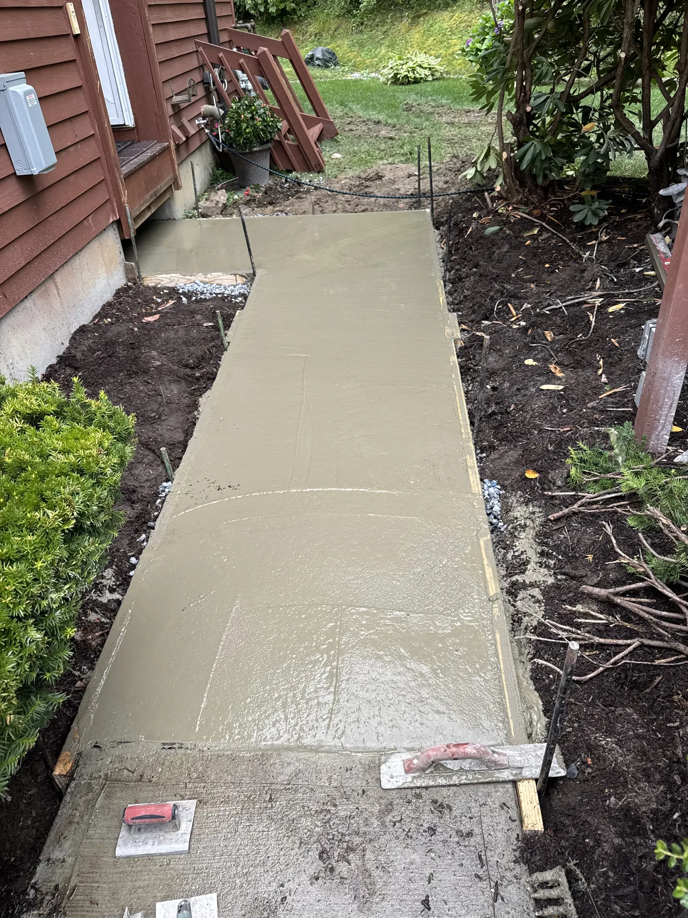 Fresh concrete walkway during the finishing process