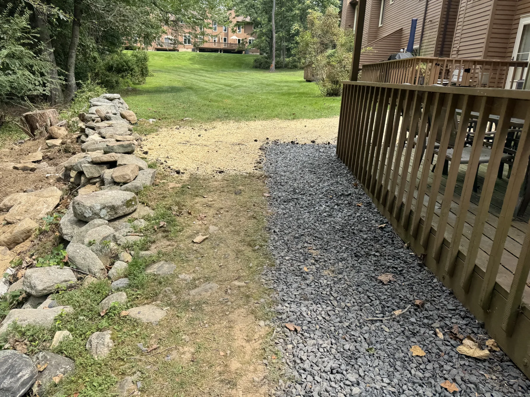 Stone drainage channel incorporated into the landscape plan